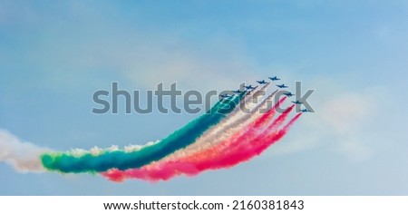 Colorful contrails of italian Frecce Tricolori aerobatic team in Sardinia, Italy