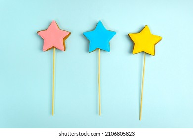 Colorful Cookies On Sticks On A Blue Background Cake Decorating Tools. Confectionery Concept. Top View.