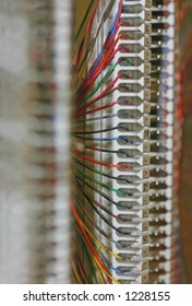 Colorful copper wires are carefully connected on a 66 block for telephone communication