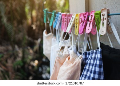 Colorful Cotton Clothes Mask Wash And Hanging With Coat Hanger And Clothespin On Window For Prevent The Covid-19 Or Corona Virus And Epidemic Disease At Thailand Health And Illness Concept.