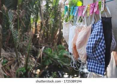 Colorful Cotton Clothes Mask Wash And Hanging With Coat Hanger And Clothespin On Window For Prevent The Covid-19 Or Corona Virus And Epidemic Disease At Thailand Health And Illness Concept.