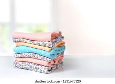 Colorful Cotton Folded Clothes Stack On White Table Empty Space Background,clean Laundry.