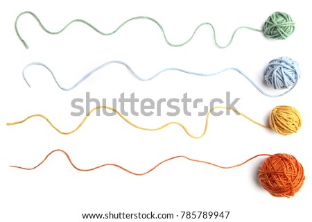 Colorful cotton thread balls isolated on white background. Set of four color (orange, yellow, green, blue) thread balls.