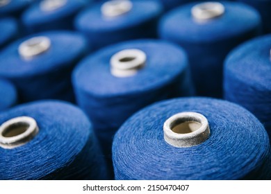 Colorful cotton yarns or threads on spool tube bobbins at cotton yarn factory. - Shutterstock ID 2150470407