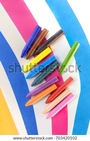 Colorful crayons against linear background