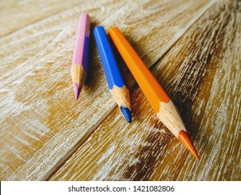 Colorful crayons on wooden table