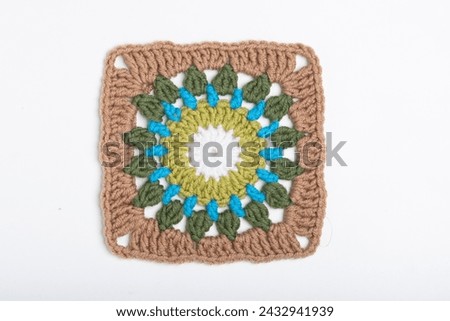 Colorful crochet granny square on a white background
