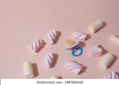 Colorful cute top view flat lay light pink background with baby concept objects with pacifier and marshmallow negative space - Shutterstock ID 1487065418
