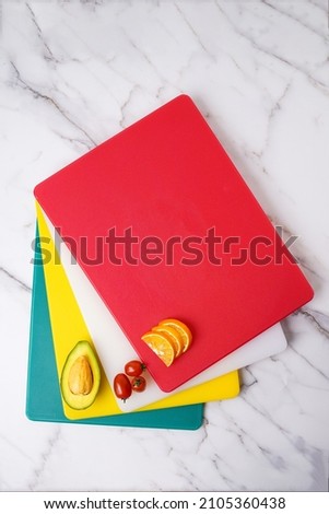 Colorful cutting board made by plastics, easy to clean and they are light weighted. 