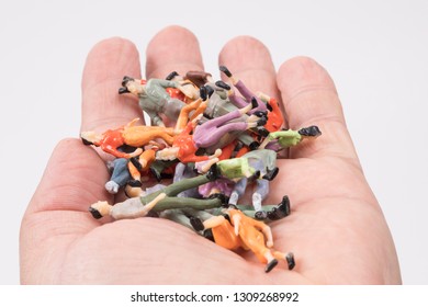 Colorful decorative human objects in the palm of hand buy background white.
