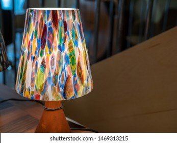 Colorful Desk Lamp With Soft Glow Sitting On Table Near A Railing