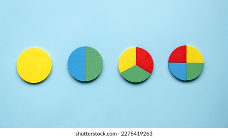 Colorful different shape of wooden pie chart pieces.