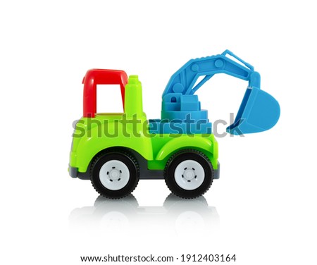 Colorful digging truck toy isolated on white background with shadow reflection, clipping, vector path. Plastic child plaything on white backdrop. Construction vehicle. Children's tractor toy.