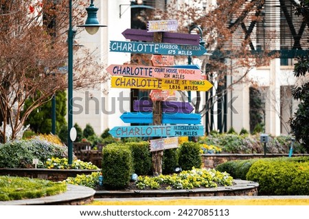 Colorful directions signs in Charlotte The Green city center park at sunny day