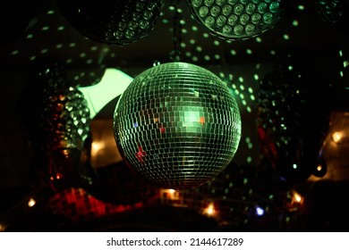 Colorful disco mirror ball lights night club background. Party lights disco ball. Selective focus. - Shutterstock ID 2144617289