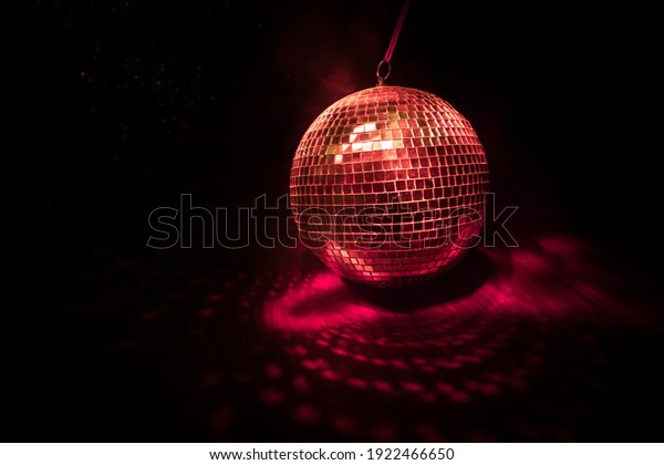 Colorful disco mirror ball lights\
night club background. Party lights disco ball. Selective\
focus