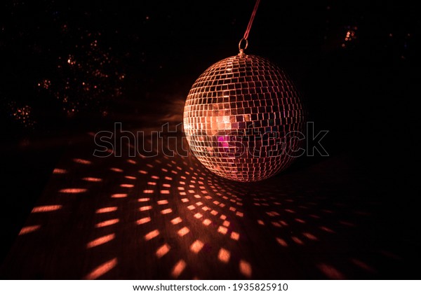 Colorful disco mirror ball lights\
night club background. Party lights disco ball. Selective\
focus