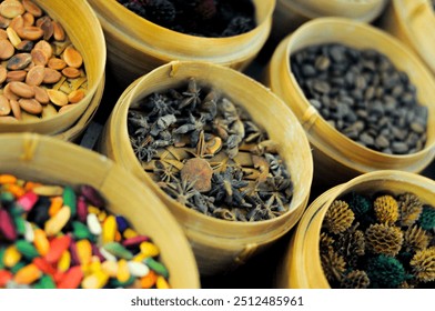 A colorful display of various spices and seeds in woven baskets. The image features star anise, colorful seeds, and other dried ingredients, showcasing the vibrant colors and textures of traditional I - Powered by Shutterstock