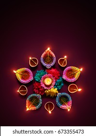 Colorful diya lamps lit during diwali celebration - Shutterstock ID 673355473