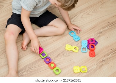 Colorful domino shapes game. Childs hand on part, connecting puzzle pieces. Montessori type educating toy. Fine motor skils. Kid Sense Child Development. - Shutterstock ID 2187162881
