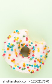 Colorful Donuts With Bite Mark Isolated On Green Background