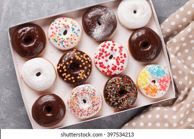 Colorful Donuts Box On Stone Table