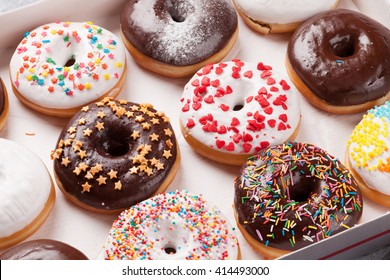 Colorful Donuts Box On Stone Table