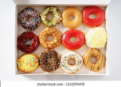 Colorful Donuts In A Row, In Paper Box , Top View