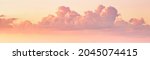 Colorful dramatic clouds lit by a sun against the sunset or sunrise sky. Cloudscape.