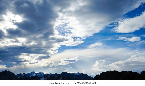 Colorful dramatic sky with cloud at sunset on mountain.