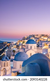 Colorful and Dramatic Sunset with Night Lights in Mediterranean Town of Oia, Santorini, Greece, Europe - Shutterstock ID 2093140228