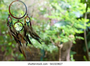 Colorful dream catcher with natural background. boho chic, ethnic amulet.