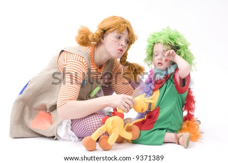 Colorful dressed Mother and daughter playing. Isolated over white