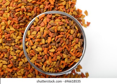 Colorful Dry Cat Dog Food In Granules Isolated On White Background. Pet Treats In Metal Bowl, View From Top Above Overhead. Copyspace For Text. 