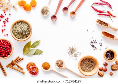 Colorful dry herbs and spices for cooking food white kitchen table background top view space for text