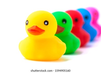 Colorful Ducks In A Row Isolated Over White. Rubber Ducks In A Row On A White Background.