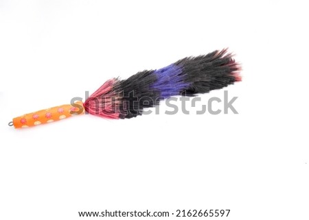 Colorful duster made of raffia plastic and wooden handle after used on white background isolated Foto d'archivio © 