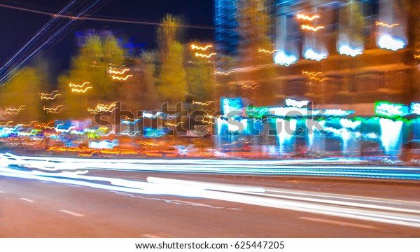 Colorful dynamic blurred night city lights on\
photo of city center Kiev,\
Ukraine