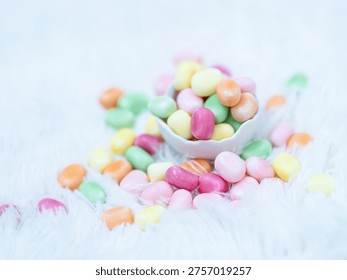 Colorful Easter candy in a small egg cup on a soft white background. Traditional seasonal sweets for Easter celebration.