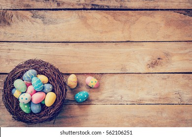 Colorful easter egg in the nest on wood background with space - Powered by Shutterstock