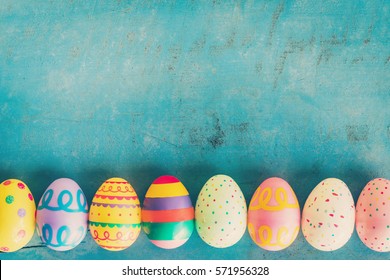 Colorful Easter Egg On Blue Pastel Color Wood Background With Space.