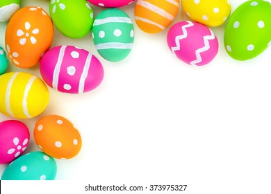 Colorful Easter egg top corner border against a white background
