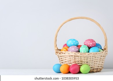 Colorful Easter Eggs In Basket On Grey Background