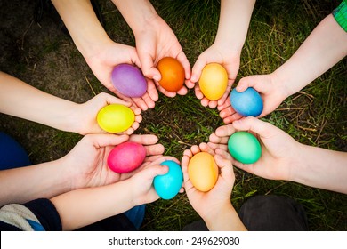 Colorful easter eggs in child hands after egg-hunt