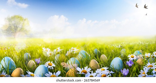 Colorful Easter eggs decorated with flowers in the grass on blue sky background - Powered by Shutterstock