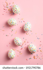 Colorful easter eggs decorated sweets on pink background. Flat lay, top view, vertical - Shutterstock ID 1921790786