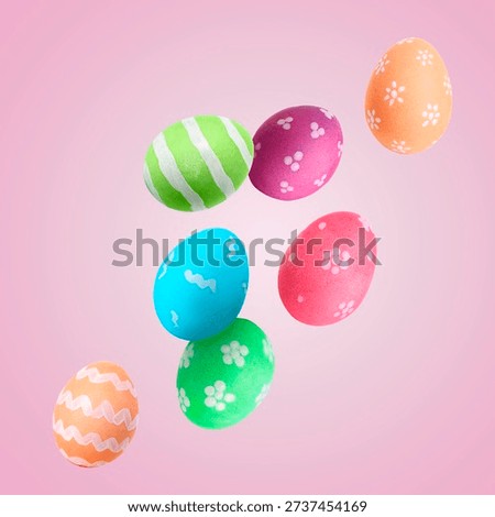 Colorful Easter eggs falling on pink background