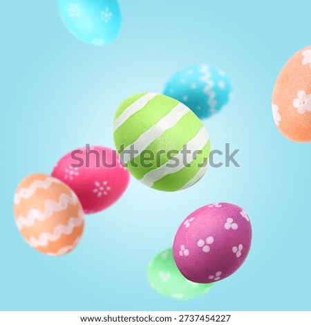 Colorful Easter eggs falling on pale blue background