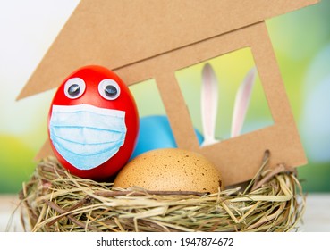 Colorful Easter Eggs In Medical Face Mask Celebration Easter Religious Holidays During House Quarantine, Lockdown Concept Of Coronavirus Covid 19 Pandemic