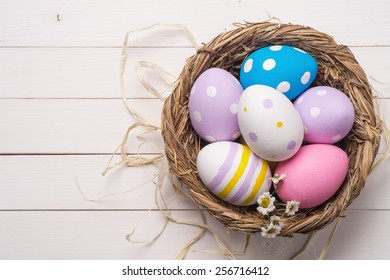 Colorful Easter Eggs In The Nest, Top View. Space For Text